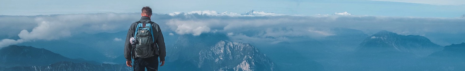 An image of a trekker walking on the Dolomites in Italy.